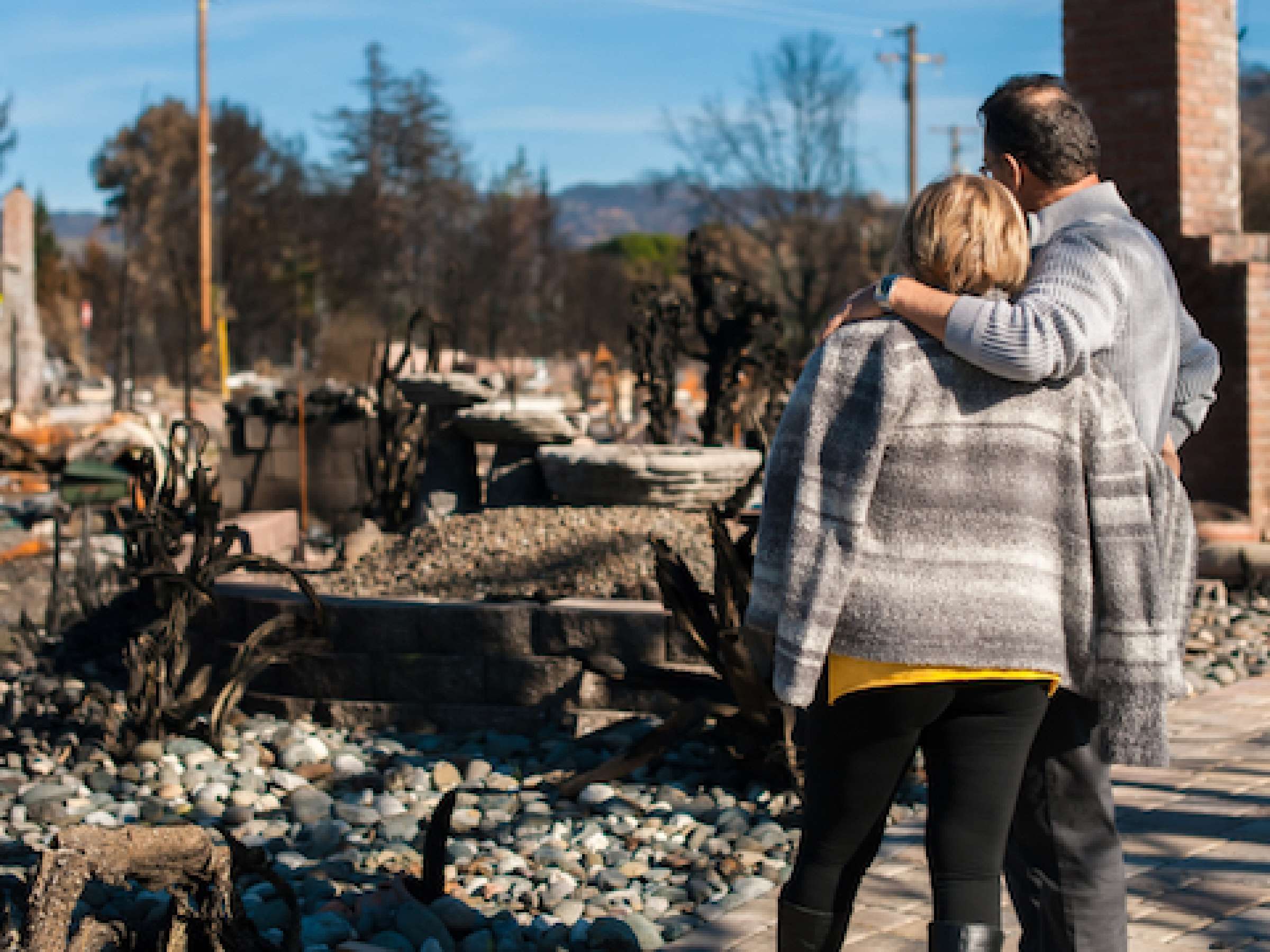 Man and his wife owners, checking burned and ruined of their house and yard after fire, consequences of fire disaster accident. Ruins after fire disaster.