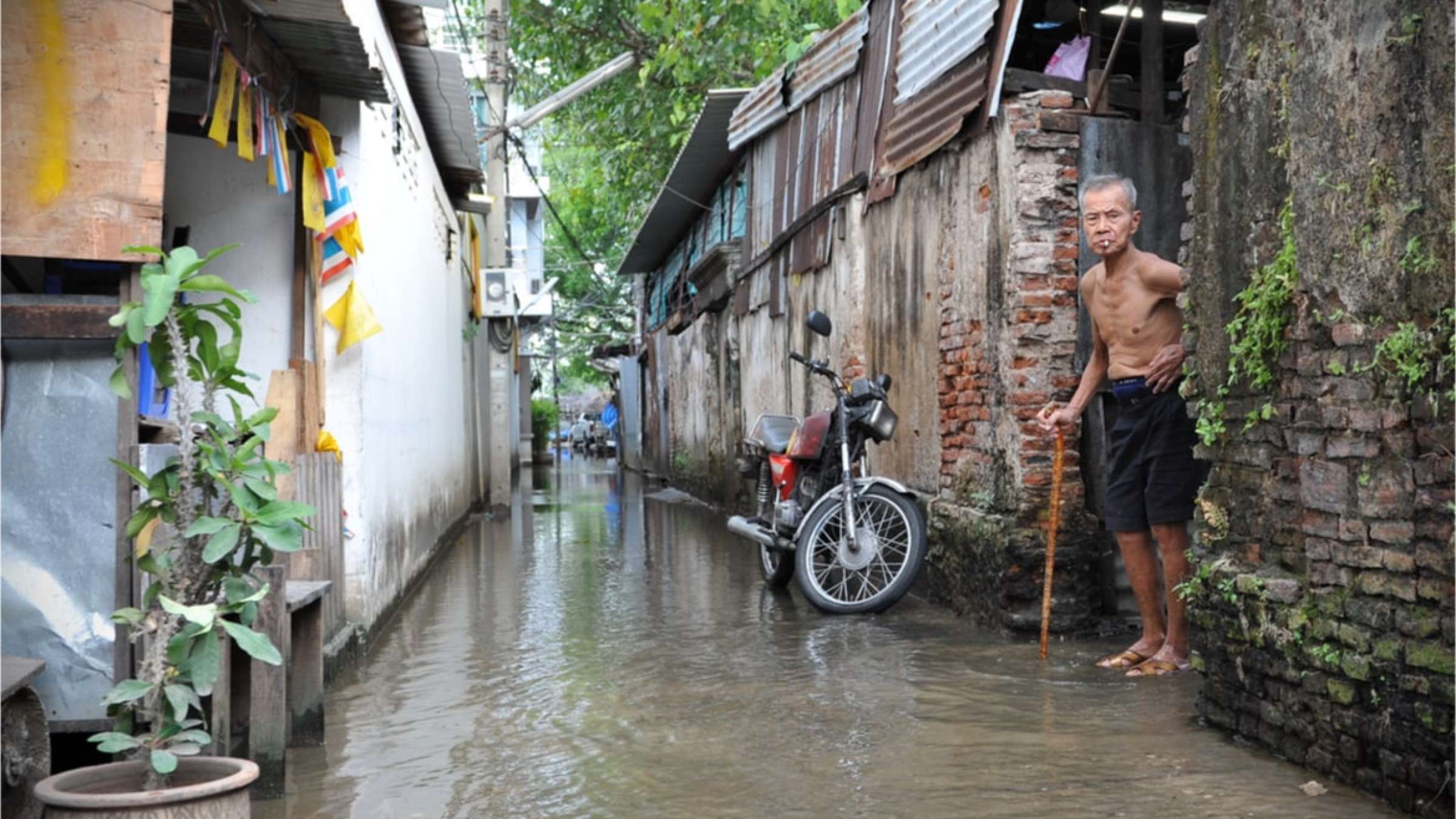 A man looks out on a flooded alley in Chinatown on Nov 22, 2011 in Bangkok, Thailand. The Thai capital is experiencing its worst flooding in decades with much of the city inundated.