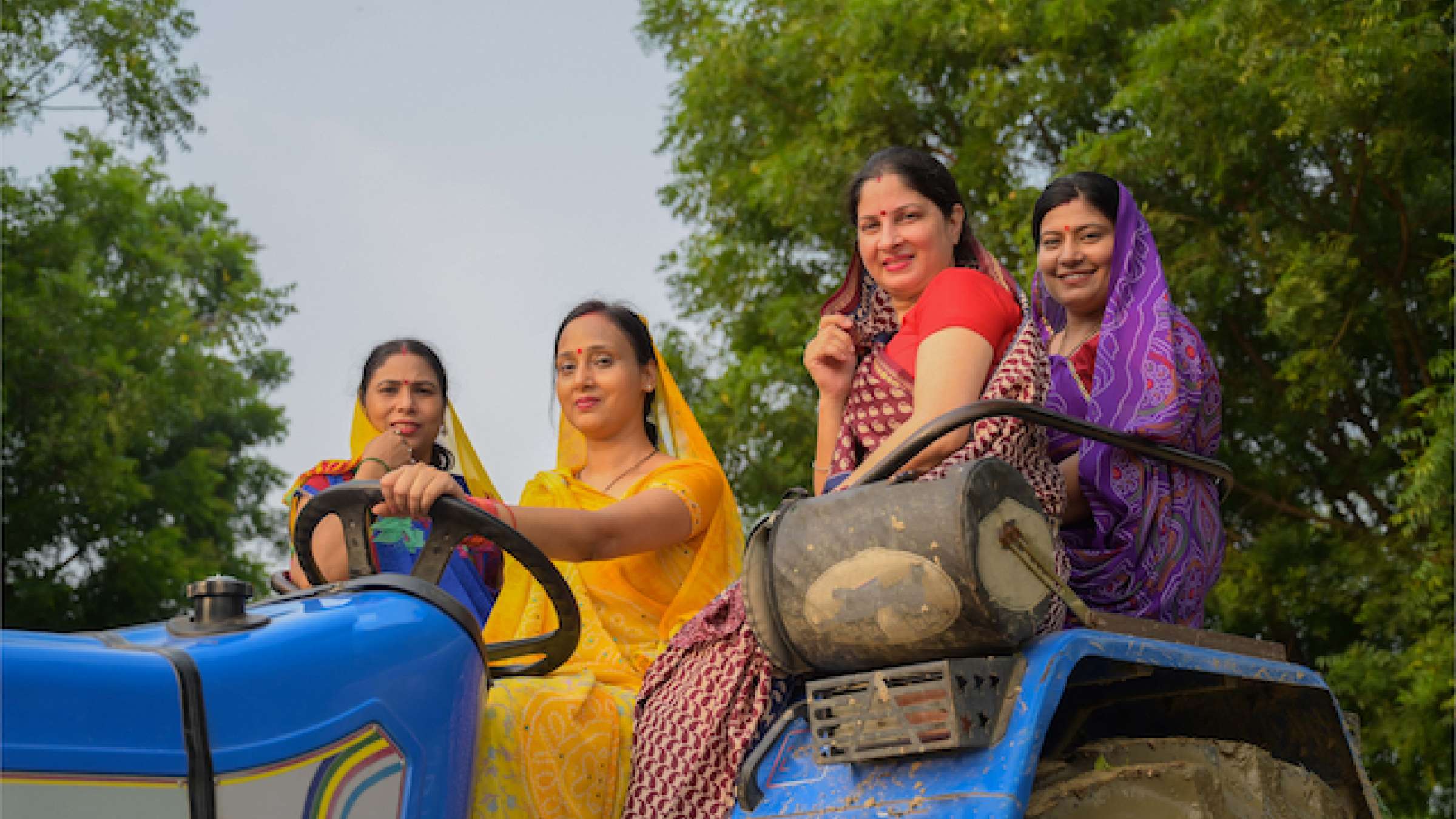 Indian women sitting on tractor