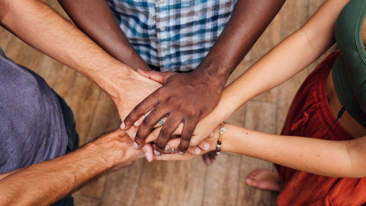 Different people stacking hands