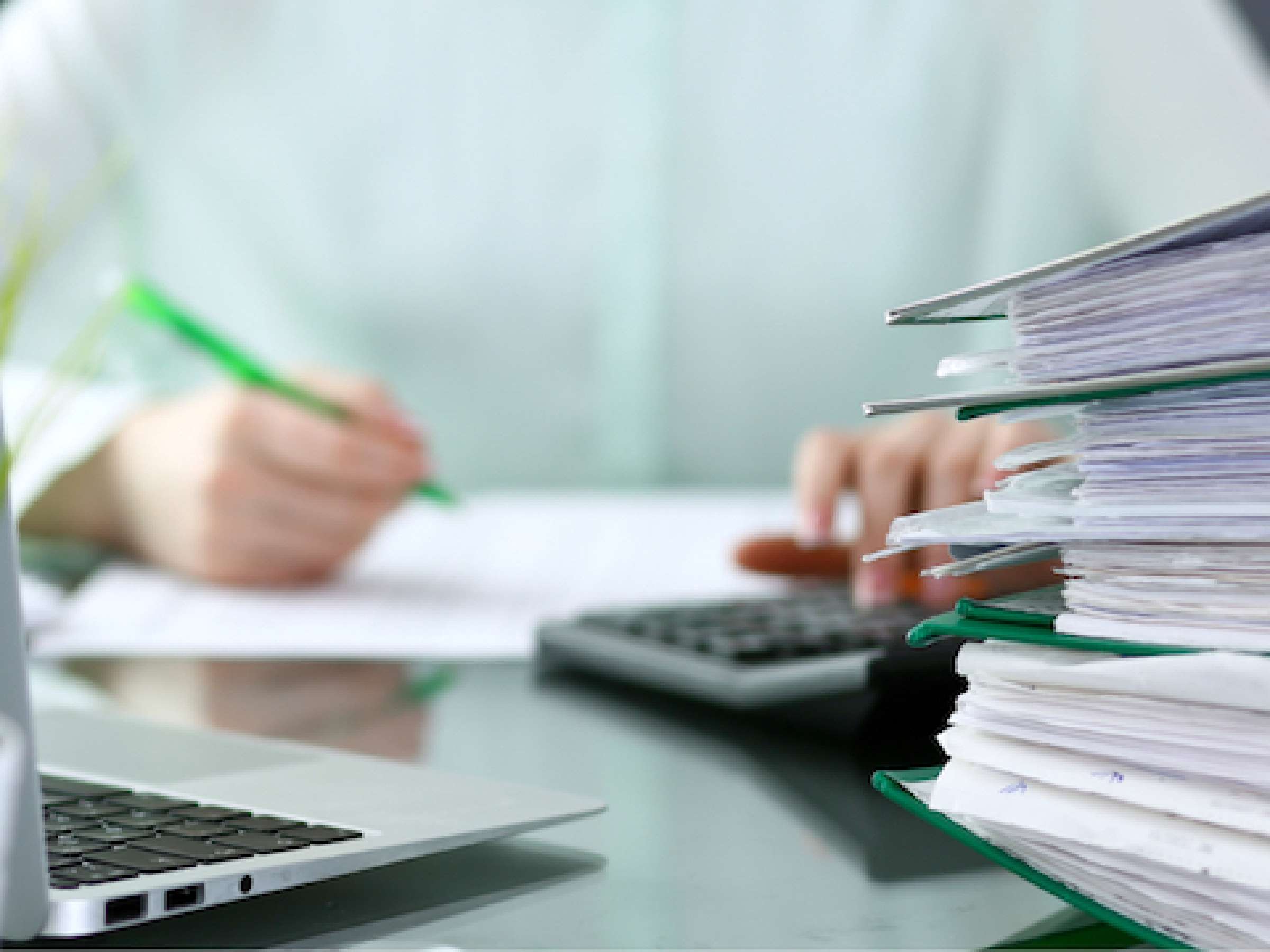 Bookkeeper or financial inspector making report, calculating or checking balance. Binders with papers closeup. 