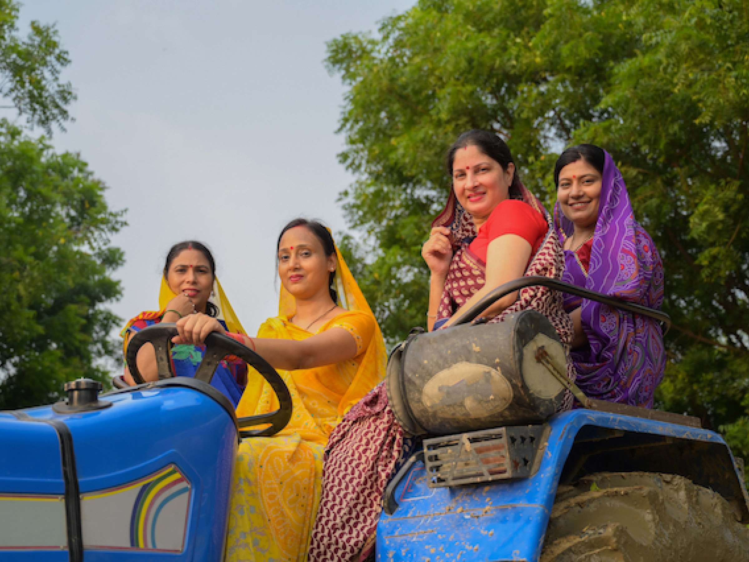 Indian women sitting on tractor
