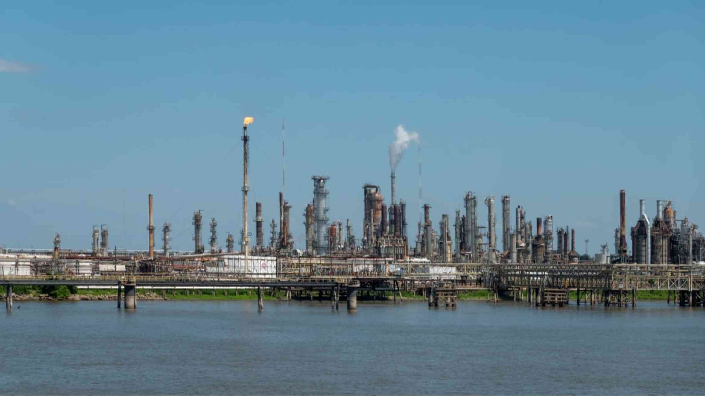 Oil refinery as seen from a river, USA.