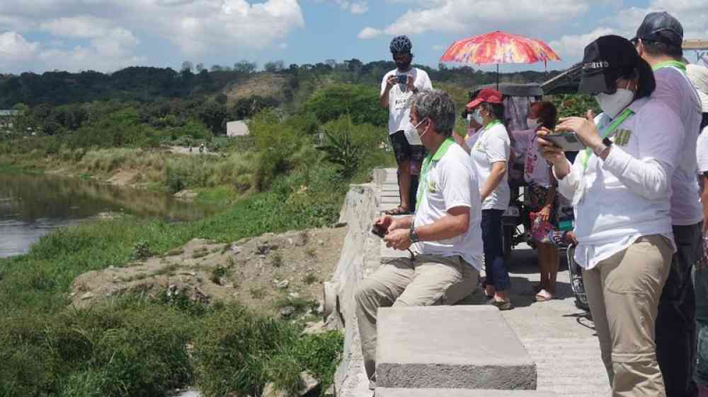 Persons doing river depth measurements  to propose flood control measures for the area