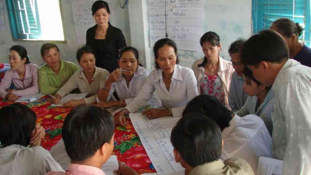 people in a meeting discussing plans