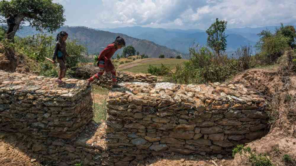 children jumping on flash flood walls in Nepal