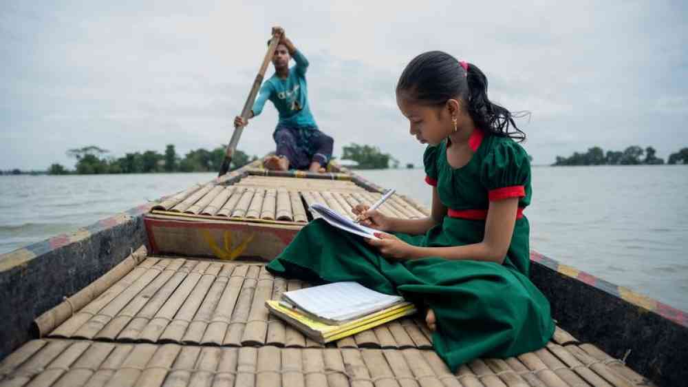 girl in boat doing homework
