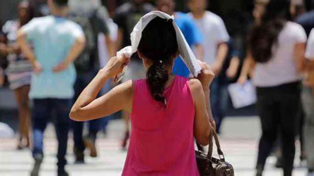 Woman trying to fend off heat in summer