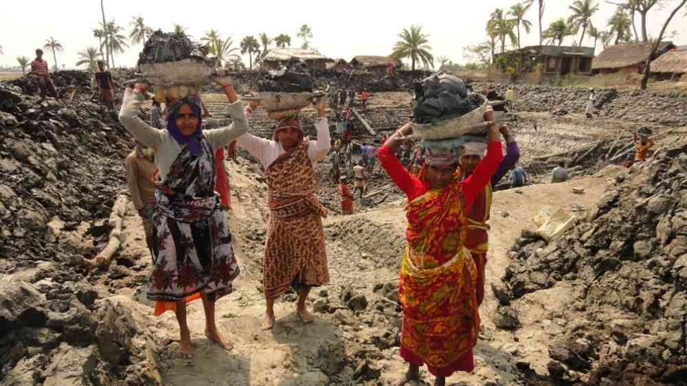 Local community women are repairing the damaged road after cyclone ‘Aila’ hit the locality in Dacope Upazila (Sub-district) of Khula district in 2013. 