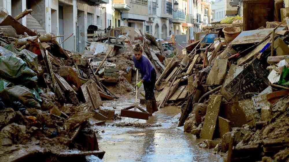 Woman clearing debris from urban flooding