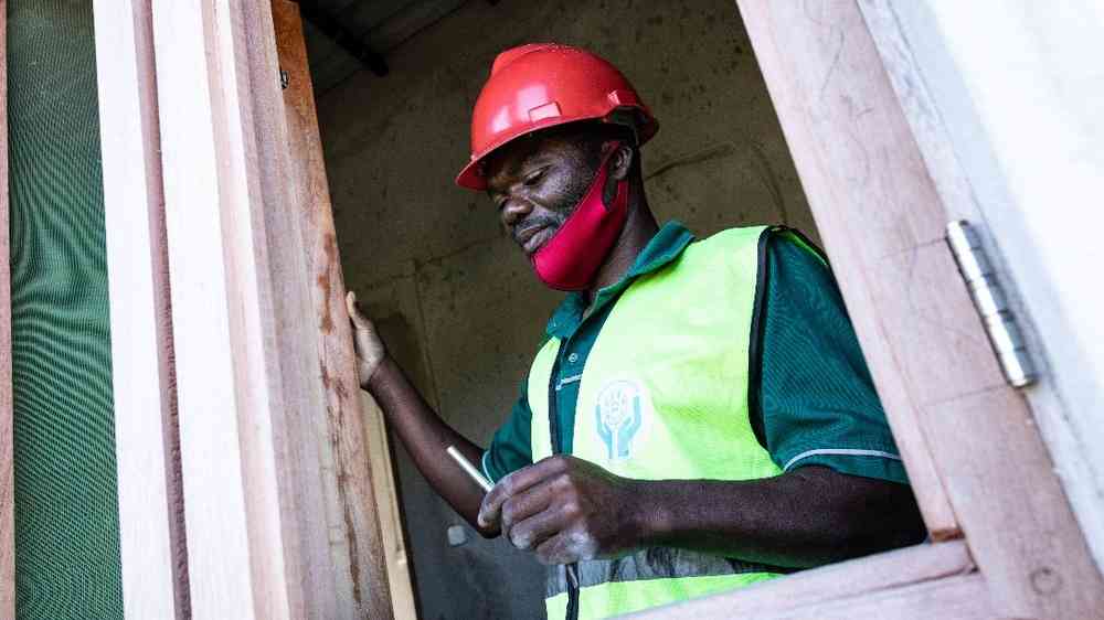 Construction worker fixing window