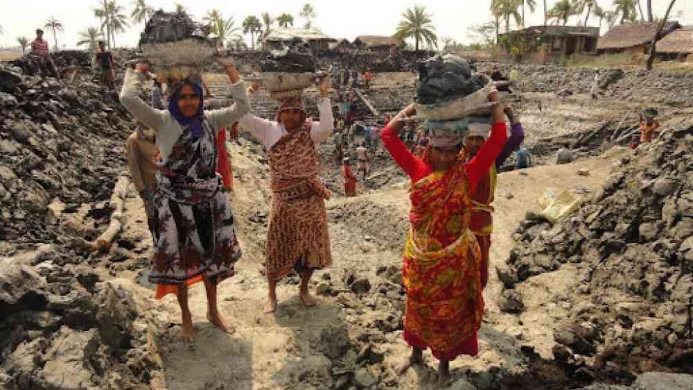 women carrying road repair material