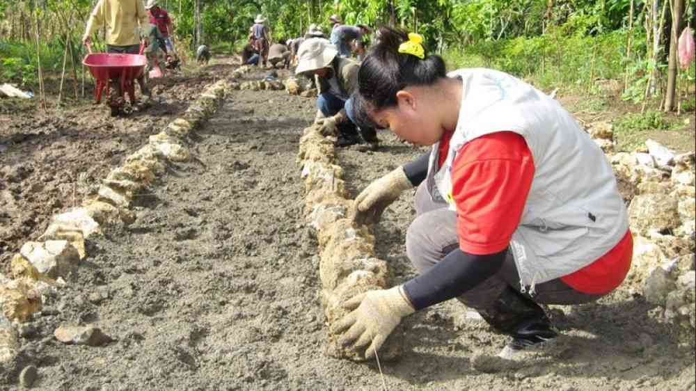 women doing road building work